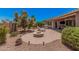 Spacious backyard featuring a fire pit, lounge chairs, and desert landscaping at 20211 N Winter Escape Ct, Maricopa, AZ 85138