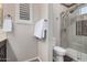 Bathroom featuring a glass-enclosed shower, white toilet, and decorative white towels at 20211 N Winter Escape Ct, Maricopa, AZ 85138