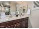 Bathroom with dual sinks, granite countertop, and tiled shower providing a luxurious feel at 20211 N Winter Escape Ct, Maricopa, AZ 85138