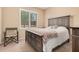 A comfy bedroom featuring neutral tones, a comfortable bed, and a window with natural light at 20211 N Winter Escape Ct, Maricopa, AZ 85138