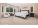 Comfortable bedroom with a work desk, sitting chair, large windows and neutral decor for a relaxing retreat at 20211 N Winter Escape Ct, Maricopa, AZ 85138