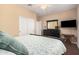 Cozy bedroom featuring neutral tones, a comfortable bed, and a view of the backyard at 20211 N Winter Escape Ct, Maricopa, AZ 85138
