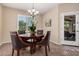 Cozy dining area with a round table, chandelier, and window with shutters for natural light at 20211 N Winter Escape Ct, Maricopa, AZ 85138