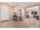 Inviting entryway with neutral tones, decorative tables, and a view into the home office at 20211 N Winter Escape Ct, Maricopa, AZ 85138