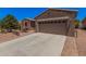 Charming single-story home with a well-maintained desert landscape, patio, and two-car garage at 20211 N Winter Escape Ct, Maricopa, AZ 85138