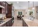 Spacious kitchen with stainless steel appliances, a center island, and an adjacent dining area for easy entertaining at 20211 N Winter Escape Ct, Maricopa, AZ 85138