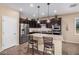 Modern kitchen with stainless steel appliances, granite countertops, and a convenient center island with seating at 20211 N Winter Escape Ct, Maricopa, AZ 85138