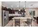 Modern kitchen with stainless steel appliances, granite countertops, and a convenient center island with seating at 20211 N Winter Escape Ct, Maricopa, AZ 85138