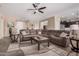 Open-concept living room with a comfortable sectional sofa, ceiling fan, and lots of space at 20211 N Winter Escape Ct, Maricopa, AZ 85138