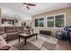 Spacious living room with a comfortable sofa, neutral tones, and natural light at 20211 N Winter Escape Ct, Maricopa, AZ 85138