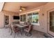 Comfortable covered patio with ceiling fan, perfect for outdoor dining and relaxation at 20211 N Winter Escape Ct, Maricopa, AZ 85138