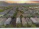 A grand aerial perspective of a neighborhood, showcasing homes with backyard patios and mountain vistas at 20872 W Thomas Rd, Buckeye, AZ 85396