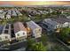 Aerial view of a well maintained community with multiple Gathering homes at sunset at 20872 W Thomas Rd, Buckeye, AZ 85396