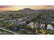 Expansive aerial shot highlights a large community with mountain views, showcasing a neighborhood lifestyle at 20872 W Thomas Rd, Buckeye, AZ 85396