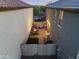 Aerial view showcases a private backyard with string lights over a cozy patio and integrated seating space at 20872 W Thomas Rd, Buckeye, AZ 85396
