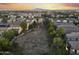Expansive aerial shot of a community showcasing homes with mountain views in the background at 20872 W Thomas Rd, Buckeye, AZ 85396
