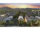 Wide aerial view features homes in a vibrant community with lush trees, streetscapes, and mountain backdrops at 20872 W Thomas Rd, Buckeye, AZ 85396