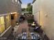Outdoor backyard space featuring dining set, fire pit, lounge chairs, string lights, and artificial turf at 20872 W Thomas Rd, Buckeye, AZ 85396