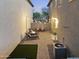 Cozy backyard oasis with string lights, pavers, seating, fire pit, and artificial turf is perfect for entertaining at 20872 W Thomas Rd, Buckeye, AZ 85396