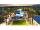 Beautiful community pool area with palm trees, ample seating, and lush landscaping at sunset at 20872 W Thomas Rd, Buckeye, AZ 85396