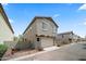 View of back of home featuring a two-car garage and low maintenance desert landscaping at 20872 W Thomas Rd, Buckeye, AZ 85396