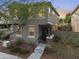Two-story home with a covered front porch, manicured landscaping, and a two-car garage at 20872 W Thomas Rd, Buckeye, AZ 85396