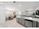 Modern kitchen boasting stainless appliances, gray cabinets, stone countertops, and tile flooring at 20872 W Thomas Rd, Buckeye, AZ 85396