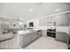 Bright, open kitchen with a large island, sleek gray cabinetry, and stainless steel appliances at 20872 W Thomas Rd, Buckeye, AZ 85396