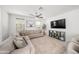 Bright living room featuring a large sectional sofa, mounted TV, and elegant decorative elements at 20872 W Thomas Rd, Buckeye, AZ 85396