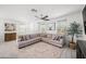 Spacious living room with neutral color palette and stylish decor, including a large sectional sofa at 20872 W Thomas Rd, Buckeye, AZ 85396