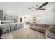 Open-concept kitchen and living room offering stainless steel appliances, tile flooring, and a cozy couch at 20872 W Thomas Rd, Buckeye, AZ 85396