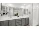 Bright bathroom featuring a double vanity, sleek fixtures, and a walk-in shower at 20872 W Thomas Rd, Buckeye, AZ 85396