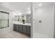 Modern bathroom with a double vanity, ample counter space, and a walk-in shower at 20872 W Thomas Rd, Buckeye, AZ 85396