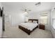Well-lit main bedroom with a king-size bed, neutral tones, and a peaceful ambiance at 20872 W Thomas Rd, Buckeye, AZ 85396