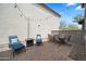Cozy outdoor patio with comfortable seating, brick pavers, and decorative string lights at 20872 W Thomas Rd, Buckeye, AZ 85396