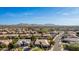 This aerial view of the neighborhood shows a view of houses, streets, and desert mountains in the background at 22323 E Via Del Jardin --, Queen Creek, AZ 85142