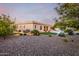 Sprawling backyard featuring lush grass, a sparkling pool, and attractive desert landscaping at 22323 E Via Del Jardin --, Queen Creek, AZ 85142