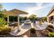 Backyard paradise with a covered patio, pool, spa, firepit and lush landscaping for entertaining at 22323 E Via Del Jardin --, Queen Creek, AZ 85142