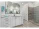 Bathroom featuring dual sinks, a large mirror, and a glass-enclosed shower for a spa-like experience at 22323 E Via Del Jardin --, Queen Creek, AZ 85142