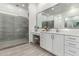 Bathroom with tiled floors, dual vanity with seating, and a glass-enclosed shower for a luxurious feel at 22323 E Via Del Jardin --, Queen Creek, AZ 85142