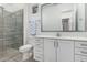 This bathroom features a glass shower, a toilet, and a sink with white cabinets at 22323 E Via Del Jardin --, Queen Creek, AZ 85142