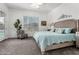 Bedroom with carpet, chair, and window featuring a ceiling fan and stylishly patterned accent pillows at 22323 E Via Del Jardin --, Queen Creek, AZ 85142