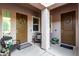 Cozy covered front porch features seating and potted plants at 22323 E Via Del Jardin --, Queen Creek, AZ 85142