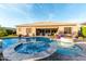 Amazing pool and spa with flowing waterfall, firepit, outdoor seating, and manicured landscaping at 22323 E Via Del Jardin --, Queen Creek, AZ 85142