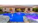 Beautifully lit pool with a spa, seating, and firepit is ready for nighttime enjoyment at 22323 E Via Del Jardin --, Queen Creek, AZ 85142