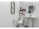 A clean, simple powder room featuring a pedestal sink and decorative wall art at 22323 E Via Del Jardin --, Queen Creek, AZ 85142