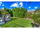 The lush backyard features well-maintained artificial grass, mature landscaping, and a private seating area at 2282 E Zion Way, Chandler, AZ 85249