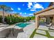 Lush backyard with a swimming pool, well-manicured landscaping, a covered patio and a lovely outdoor dining area at 2282 E Zion Way, Chandler, AZ 85249
