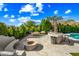 Large backyard featuring an outdoor kitchen, patio area, and a cozy fire pit at 2282 E Zion Way, Chandler, AZ 85249