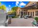 An outdoor entertaining area features string lights, covered lounge space, a fireplace, and a trampoline at 2282 E Zion Way, Chandler, AZ 85249